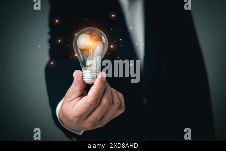 Smart intelligent creativity with bulbs, Motivation and innovation concept, Businessman holding illuminated lightbulb, idea, innovation and inspiratio Stock Photo