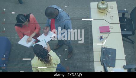 Image of computer language and lines, high angle view of diverse coworkers discussing reports Stock Photo