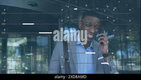 Image of computer language and lines over african american businessman talking on cellphone Stock Photo