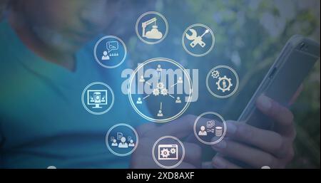 Image of multiple digital icons spinning over mid section of biracial boy using smartphone Stock Photo