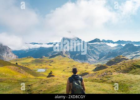 Young traveler with backpack hiking mountain. Travel Lifestyle and Adventure concept. Stock Photo