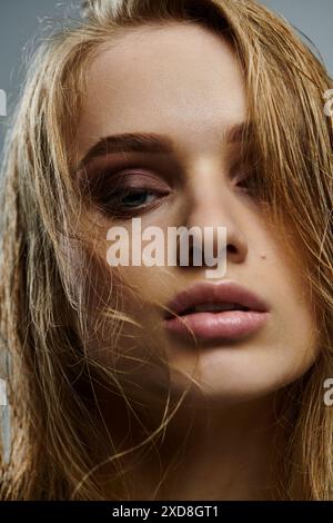 A young woman showcasing her wet, long hair. Stock Photo