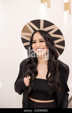 Woman smiling looking to the side with long lashes and wide brim Stock Photo