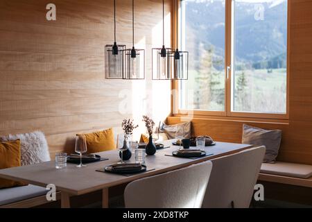 Modern dining table with elegant table setting and large windows Stock Photo