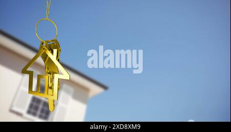 Image of golden key and house over house and blue sky Stock Photo