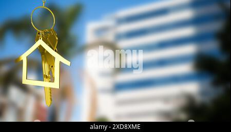 Image of golden key and house over cityscape Stock Photo