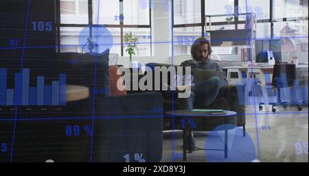 Image of statistical data processing against caucasian man using laptop at office Stock Photo