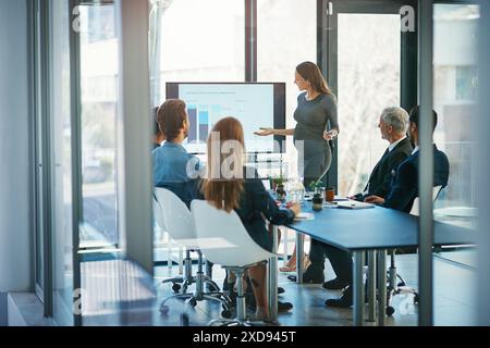 Office, presentation and woman with chart on screen for kpi analysis, company growth or report. Boardroom, data analyst and business people with Stock Photo