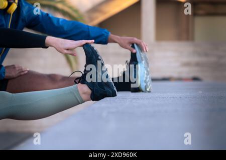 Unrecognizable young couple doing stretching. Stock Photo
