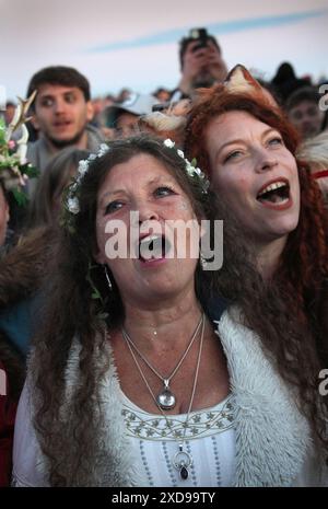 June 21, 2024, Salisbury, England, UK: A selection of attendants wearing animal ears and a floral crown chant during a ceremony while waiting for the sun to rise as part of the Summer Solstice celebrations at Stonehenge. Stonehenge was built by early Britons some 4000 years ago to align with the sun on the solstices. The summer solstice marks the end of Spring and the start of Summer and is the longest day and the shortest night in the Northern Hemisphere. The event is celebrated by thousands of pagans worldwide with singing and dancing. (Credit Image: © Martin Pope/ZUMA Press Wire) EDITORIAL Stock Photo