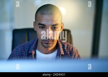 Computer, face and serious with developer man in office for coding, programming or web design. Internet, software and technology with confident Stock Photo
