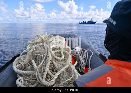 (240621) -- SANSHA, June 21, 2024 (Xinhua) -- A law enforcer of China Coast Guard is pictured on the way to Chinese fishing boats with retrieved fishing nets in China's Ren'ai Jiao and the surrounding territorial sea, June 11, 2024. Recently, in China's Ren'ai Jiao and the surrounding territorial sea, personnel from the illegally grounded Philippine navy transport ship repeatedly damaged Chinese fishermen's nets and deployed the illegally obtained fishing nets to the nearby waters of their ship to obstruct the law enforcement of China Coast Guard (CCG).  CCG law enforcers have retrieved these Stock Photo