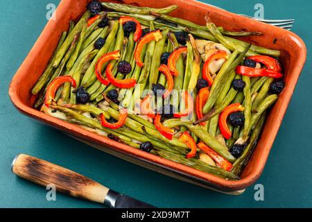 Homemade baked vegetable pie with green or bush beans and peppers in baking dish. Stock Photo
