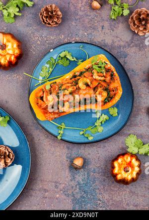 Half a butternut squash stuffed with vegetables and shrimp. Top view. Stock Photo
