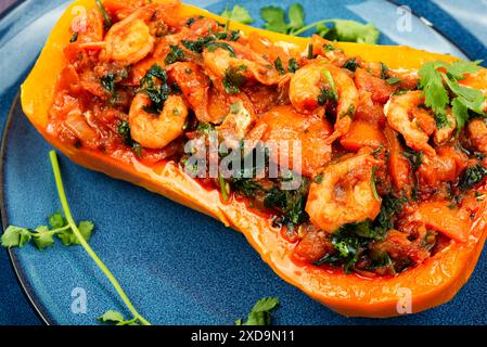 Butternut squash stuffed with peppers, tomatoes and shrimp. Brazilian dish. Stock Photo
