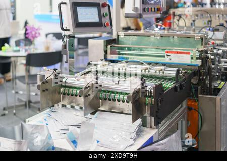modern packaging machine used in an industrial setting, likely for packing medical supplies, food products Stock Photo