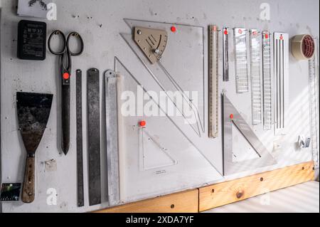 Set squares and rulers arranged on pinboard in Camden studio, London, UK Stock Photo