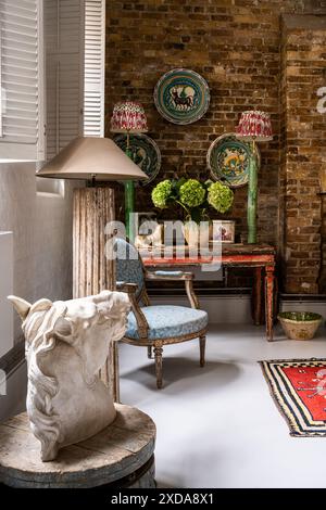 Lebrillo ceramic dishes and horse's head with antique furniture in late 19th century Victorian school house, Battersea, London, UK Stock Photo