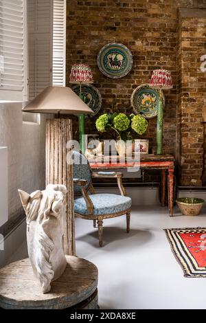 Lebrillo ceramic dishes and horse's head with antique furniture in late 19th century Victorian school house, Battersea, London, UK Stock Photo