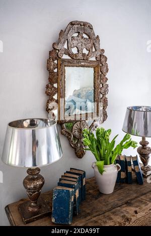 Silver gilt mirror and lamp bases on Italian commode in late 19th century Victorian school house, Battersea, London, UK Stock Photo