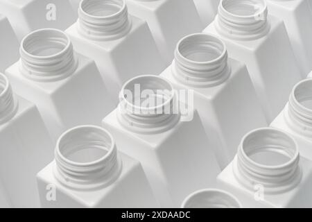 Large group of empty white plastic bottles ready to be filled or recycled, packaging or production line, abstract industrial background Stock Photo