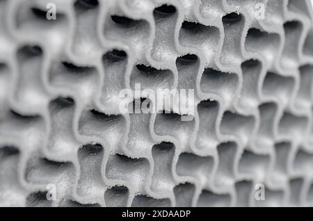 3D-printed metal wavy grid,  three-dimensional openwork lattice close up shot. Abstract modern technology background. Stock Photo