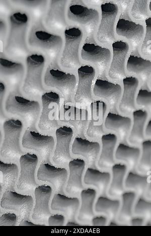 3D-printed metal wavy grid,  three-dimensional openwork lattice close up shot. Abstract modern technology background. Stock Photo
