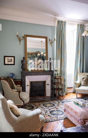 Armchairs at fireside in renovated stone-built hotel particulier dating from 1770 in Saulieu, Burgundy, France. Stock Photo