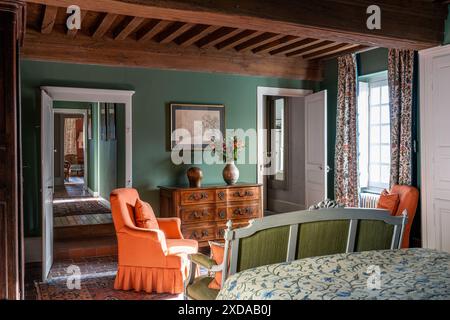 Beamed ceiling and antique chest of drawers in bedroom of renovated stone-built hotel particulier dating from 1770 in Saulieu, Burgundy, France. Stock Photo