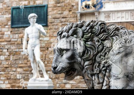 Statue of lion at Loggia Dei Lanzi in front of Florence Palazzo Vecchio and statue of David in Florence, Italy. Architecture and landmark of Florence, Stock Photo