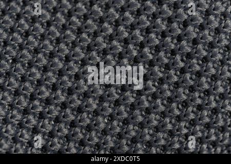 Close up detail of grey knitted fabric texture background. Macro Stock Photo