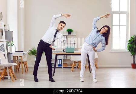 Business and healthy ofice lifestyle, young office workers doing fitness exercise at workplace Stock Photo