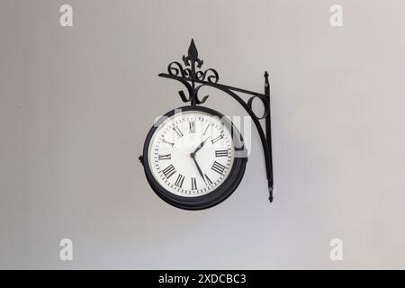 Close-up detail of black old city clock in home interior on white background. Horizontal Stock Photo