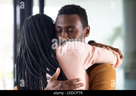 Hugging each other warmly, young couple at home Stock Photo