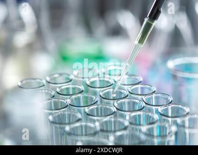 Scientist extracting samples using a pipette for analytical testing in the lab. Stock Photo