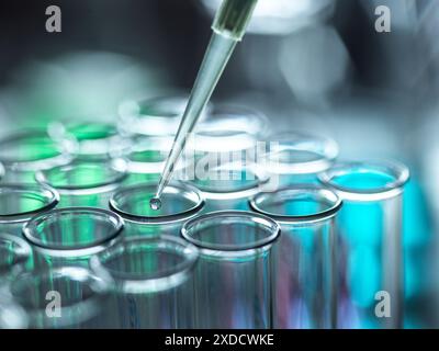 Scientist extracting samples using a pipette for analytical testing in the lab. Stock Photo