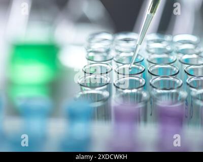 Scientist extracting samples using a pipette for analytical testing in the lab. Stock Photo