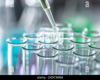 Scientist extracting samples using a pipette for analytical testing in the lab. Stock Photo