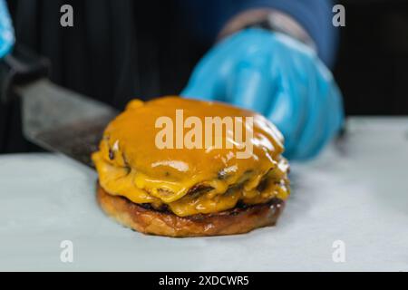 Cheeseburger without top bun. Stock Photo