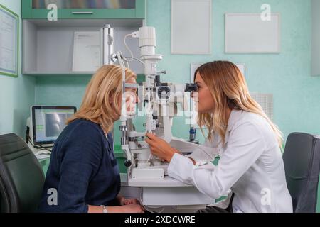 Eye examination with a slit lamp in a professional ophthalmology setting. Stock Photo