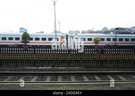 A train is stopping at a quiet station in the morning Stock Photo