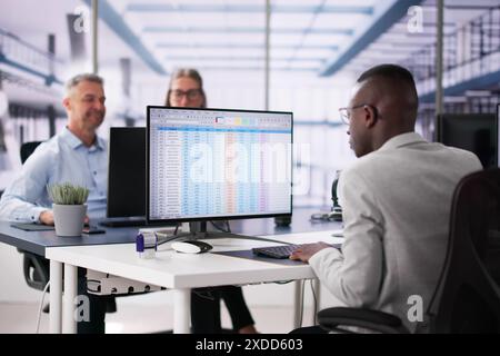 Data Analyst African Woman Using Spreadsheet On Computer Stock Photo