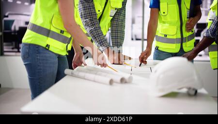 Civil Engineer Or Architect Team With Construction Plans Stock Photo