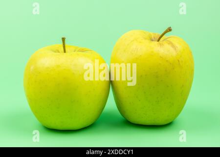 two apples, close-up, isolated on a green background Stock Photo