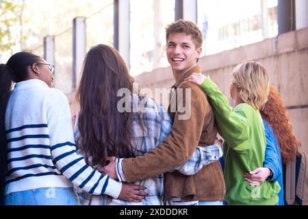 Rear view five multiethnic students on their way to university outdoors. Stock Photo