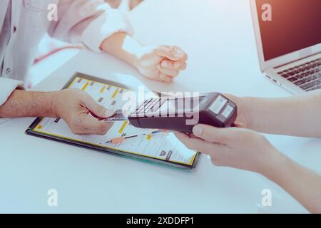 Customer using Credit Card payment with portable Swipe Magnetic Credit Card Reader Terminal machine. Stock Photo