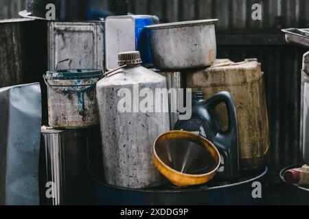 Black old used dirty motor oil in garage liquid waste from engine drain dump impact environment Stock Photo