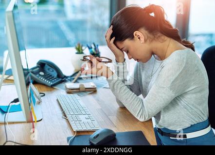 Burnout, headache or stress with web developer woman at desk in office for online administration. Anxiety, design and mental health with frustrated Stock Photo