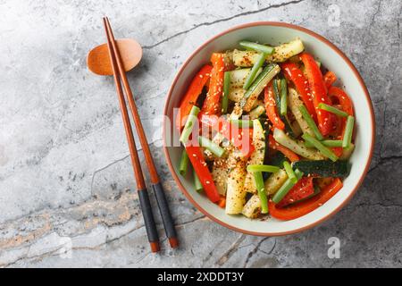 Zucchini And Bell Pepper Stir Fry closeup on the plate on the table. Horizontal top view from above Stock Photo