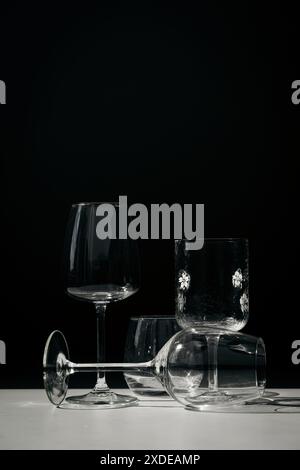 Assorted glassware for various drinks in sunlight. Stock Photo
